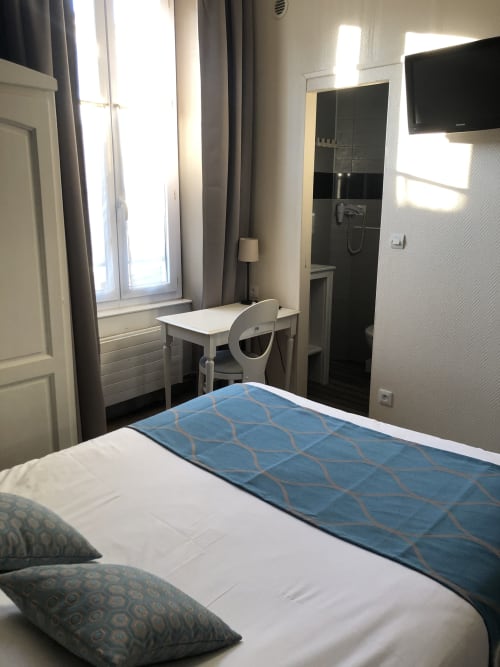 Double bedroom at Hôtel Maison Richet, Les Sables-d'Olonne, with bed, desk, shower room and TV