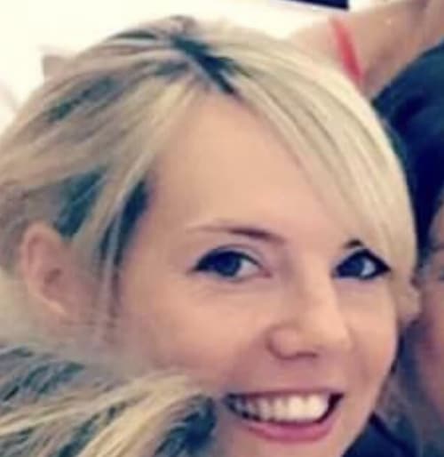 Smiling woman with blonde hair and blue eyes at Manoir de la Nogrie hotel in Val d'Izé, France