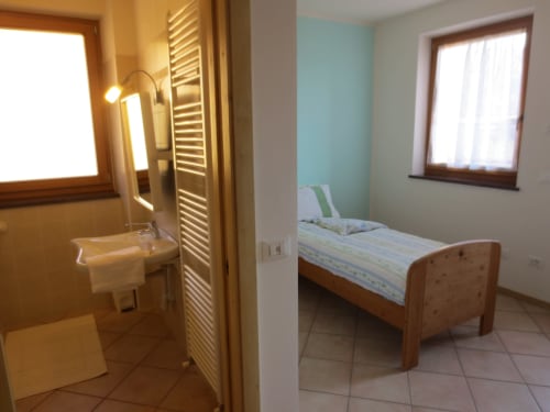 Camera singola | Agritur Clementi, camera singola, Trentino, verde, ampio bagno privato con doccia, televisore a parete, Wifi, appendiabiti, asciugacapelli, balcone con vista sul giardino.