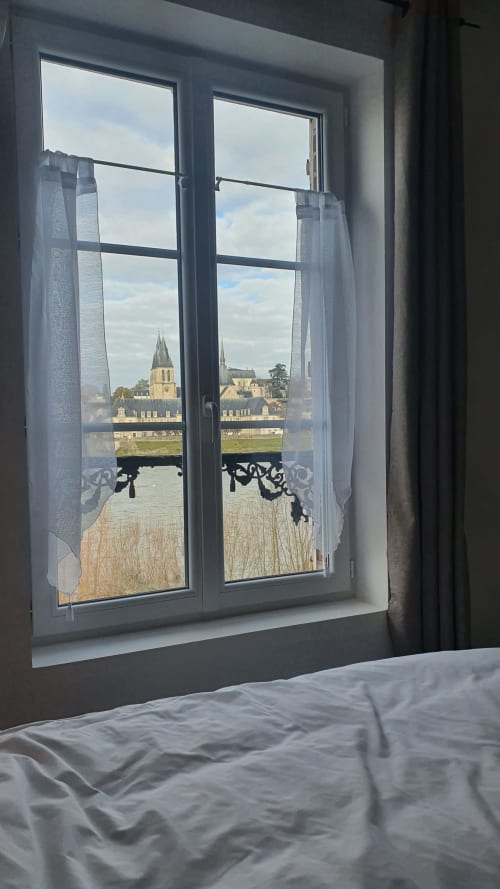 View from Gîte Des Cygnes cottage window overlooking Loire River and Blois church spires, France