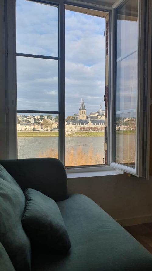 View from Locacharme cottage in Blois: Tuffeau Cathedral and Loire River from window with armchair