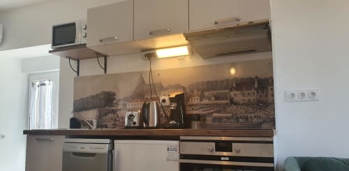Modern kitchen in Locacharme cottage, Blois with stainless steel appliances and scenic city view backsplash