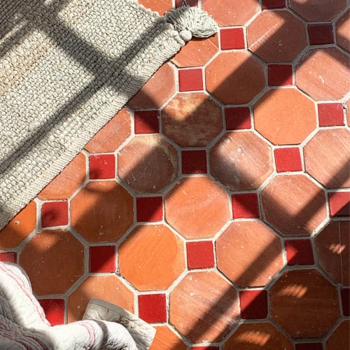 Decorative red and orange tile floor detail at Domaine Du Commandeur in Mondragon, France