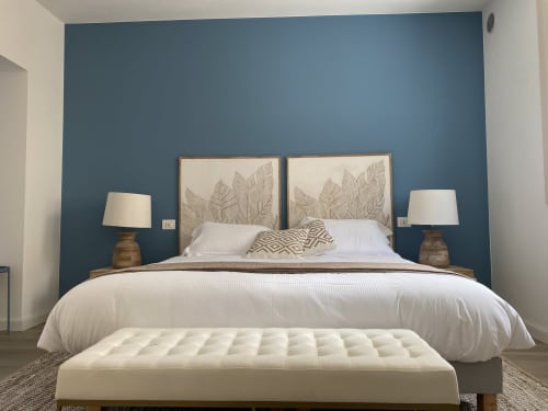 Modernes Schlafzimmer im Verdolivo B&B in Sale Marasino mit blauer Akzentwand, Kopfteil mit Blattmuster und weißer Bettwäsche