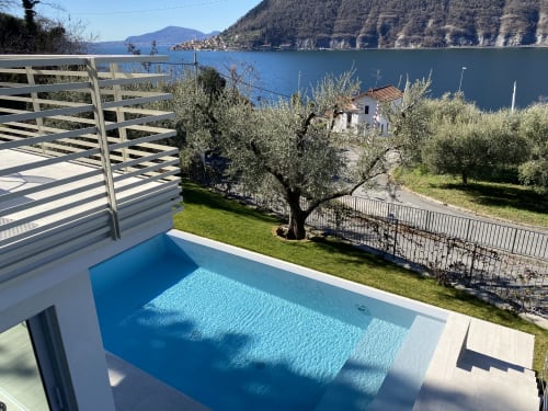 Verdolivo lakeside pool with blue water, olive trees, and Lake Iseo views in Sale Marasino, Italy