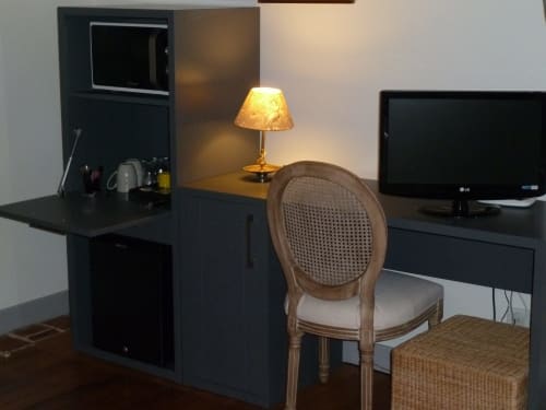 Bureau moderne avec chaise en bois, téléviseur écran plat et luminaire d'ambiance dans la chambre Lilas du Château De Clusors, St Menoux