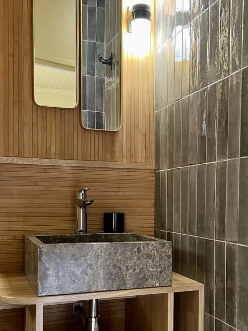 Marbre, laiton, faïence, bois de chêne et bambou pour une salle de bain confortable et authentique