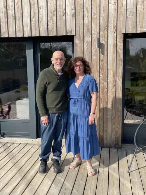 Two guests posing on wooden deck at Manoir de la Nogrie hotel in Val d'Izé, France