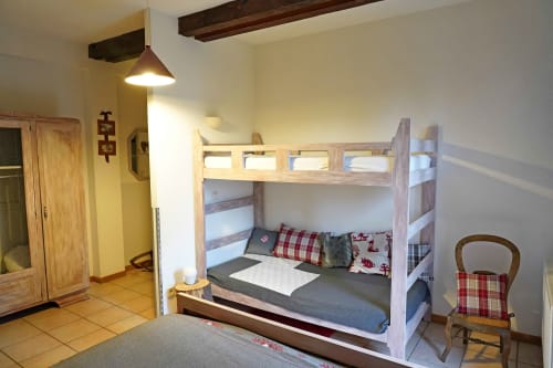 Morille room at L'étape Du Fanfoué in Chamrousse with wooden bunk bed, red plaid pillows, and mountain views