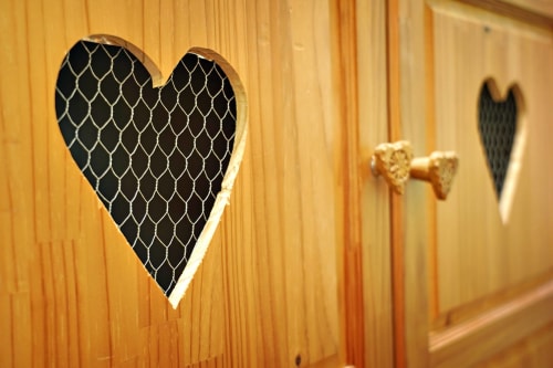 Decorative wooden wall art with heart and arrow designs at L'étape Du Fanfoué, Chamrousse
