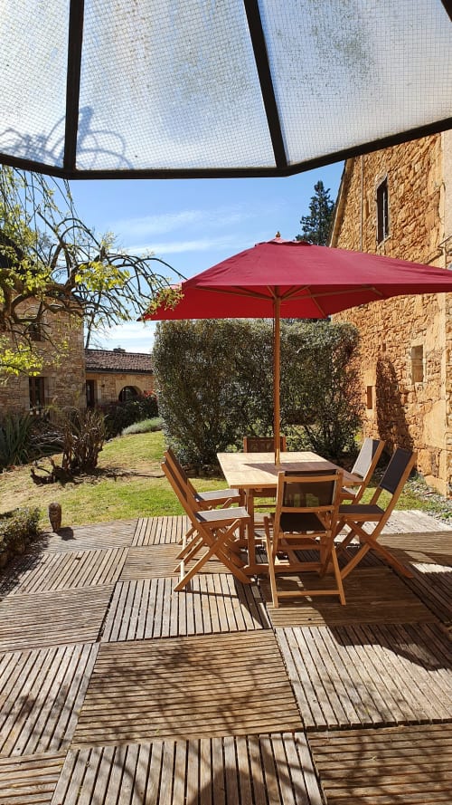 Shaded terrace of Cristal Cottage under canopy, ideal for outdoor dining.