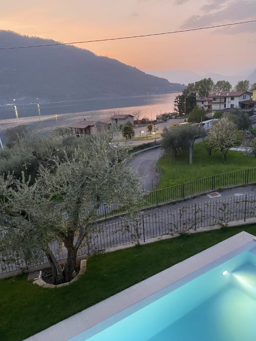 Verdolivo lakeside B&B in Sale Marasino with pool, olive tree, and sunset view of Lake Iseo