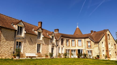 Le Petit Château bed and breakfast in Baye, France - stone manor house with terracotta roof and manicured lawn