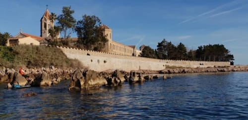 Cannes monastery with stone walls overlooking Mediterranean Sea rocky coastline