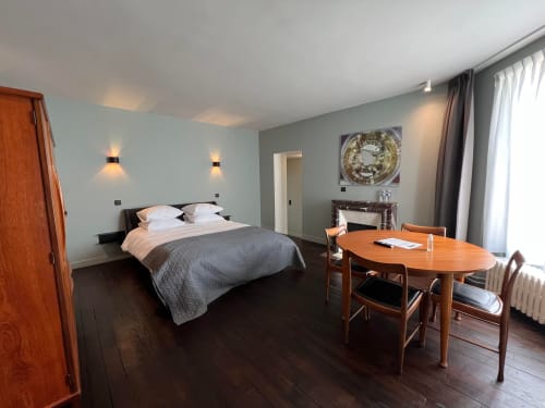 Salomon room at Le Petit Château in Baye with queen bed, wooden desk, and garden view
