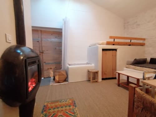 Furanelle B&B lounge in Saint Etienne with fireplace, furniture, and wooden architectural elements