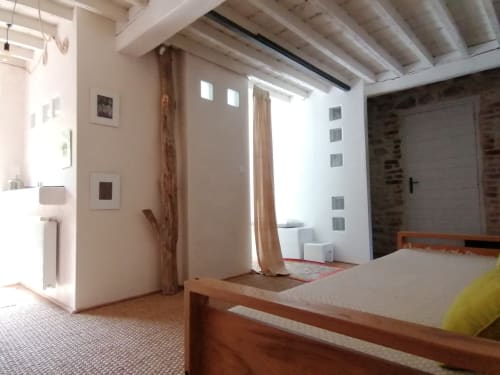 Chambre moderne à la Furanelle B&B à Saint Étienne avec lit en bois, poutres apparentes et vue sur les montagnes