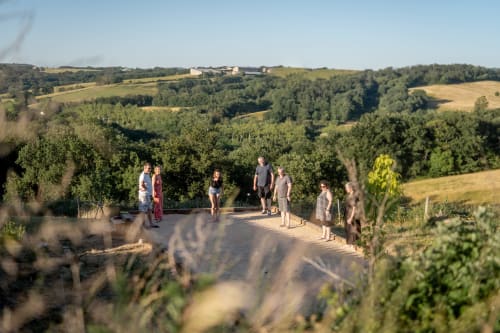 Guests gathering on a terrace overlooking rolling countryside at Le Pignié B&B in Lescure-d'Albigeois, France