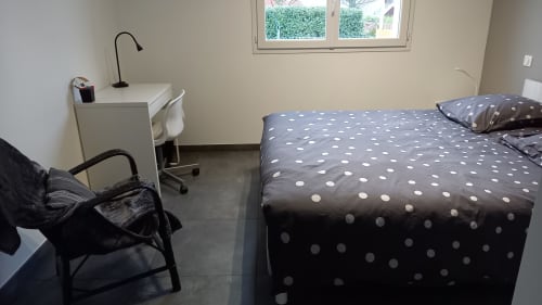 Chambre accueillante au Chez Anne Marie B&B à Beausemblant avec parure à pois, bureau, chaise et vue sur le jardin