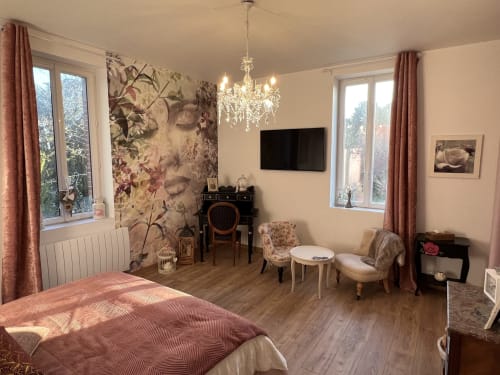 Elegantes Familienzimmer des Château Ségot mit Gartenblick, Blumentapete, Kronleuchter, Fernseher und Sitzbereich