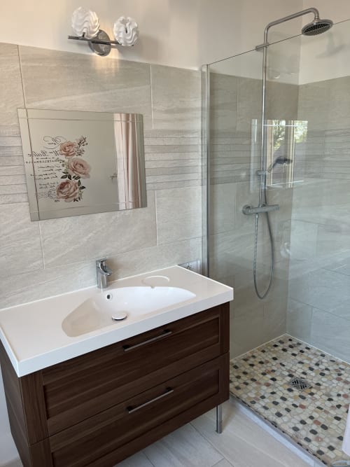 Modernes Badezimmer im Gabrielle d'Estrées Zimmer des Château Ségot, Neuilly-le-Réal, mit Glasdusche und Waschtisch.