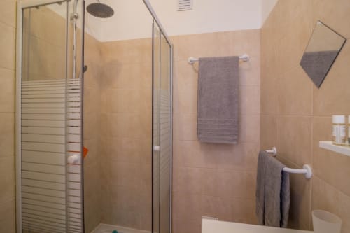 Modern bathroom with walk-in shower and glass enclosure at Armação Beach Residences apartment in Armação de Pêra