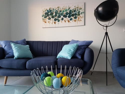 Canapé bleu moderne avec coussins turquoise et bol coloré dans l'appartement de Corbara