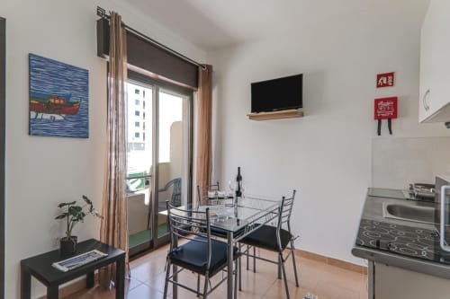 Modern apartment dining area with city view balcony at Armação Beach Residences, Armação de Pêra