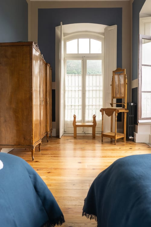 Suite Pintueles en La Venta de Miyares con muebles de madera, puertas arqueadas, balcón con vistas a la montaña y tapizado azul