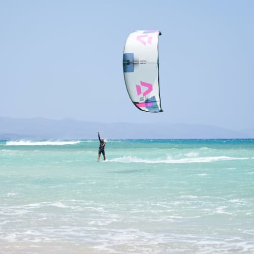 Kitesurfer in turquoise waters at Can Picafort beach near Hotel Sa Roqueta