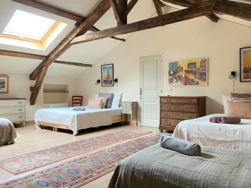Spacieuse chambre mansardée aux Lumieres Du Causse avec poutres apparentes, plusieurs lits, mobilier bois et puits de lumière