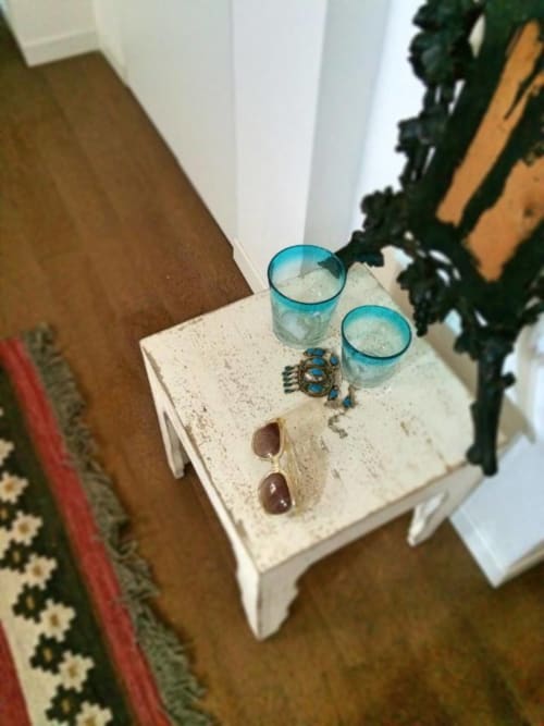 Blue glasses with water and jewelry on white table in Venice apartment Ca Cortigiane