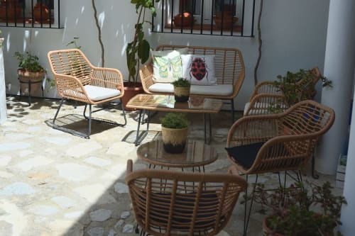 Rattan furniture in sunny courtyard at La Casa De La Abuela Regina, Grazalema