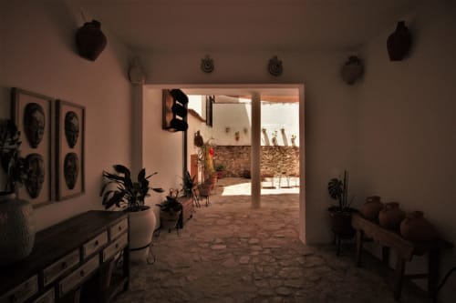 Interior entryway of La Casa De La Abuela Regina in Grazalema with terracotta floors, rustic furnishings, and traditional
