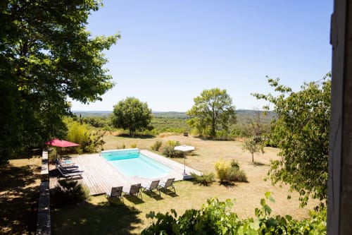 Private swimming pool and terrace with mountain views at Les Lumieres Du Causse cottage in Bellefont-La Rauze, France