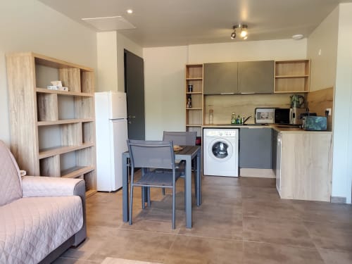 Open-plan apartment kitchen and living area at Villas Lantana in Lecci with modern amenities including washing machine and