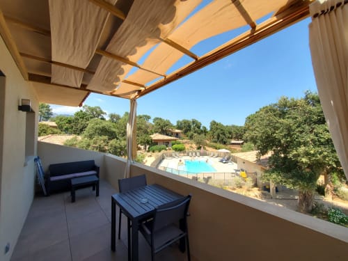 Balcony with pergola and shaded seating overlooking pool at Villas Lantana, Lecci