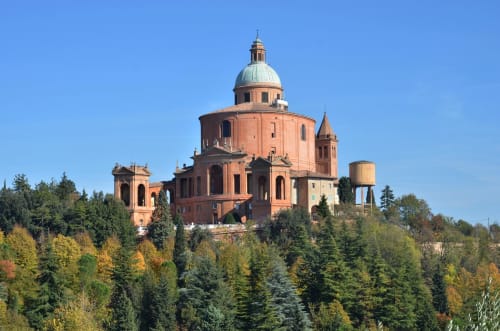 Sanctuary of Madonna di San Luca basilica on hilltop near Bologna, Italy with autumn foliage and clear sky
