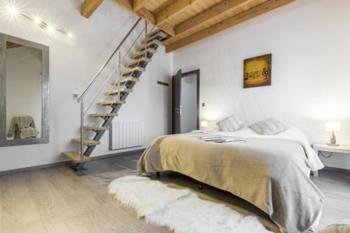 Modern bedroom at Les Edelweiss Mont-Blanc in Passy with queen bed, loft staircase, and mountain views