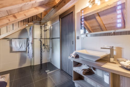 Modern bathroom in Suite Dôme du Goûter at Les Edelweiss Mont-Blanc, Passy, with walk-in shower and wooden vanity