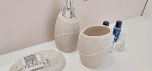 Bathroom amenities at Charm Discovery Experiences B&B in Leiria, Portugal featuring ceramic toiletries holder, soap