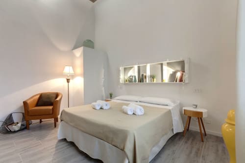 Modern Superior Apartment bedroom at Sleep tight Florence B&B in Firenze with queen bed, orange chair, and wall-mounted