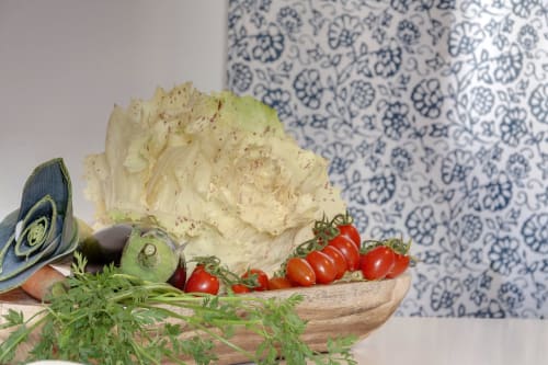 Fresh vegetables and herbs on wooden board in Florence apartment kitchen at Sleep tight B&B