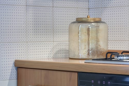 Decorative glass jar with brass lid on wooden dresser in Sleep tight Florence apartment