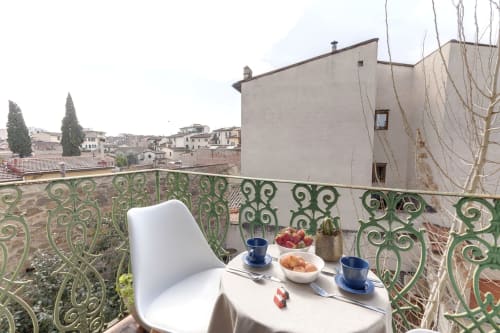 Balcony breakfast setup at Sleep Tight Florence BnB with Florence rooftops view and Tuscan architecture