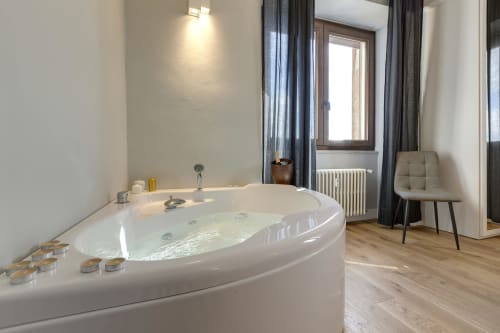 Luxurious Jacuzzi bathtub in Sleep tight Florence suite with city views, candles, modern amenities