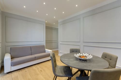 Suite moderna con divano grigio, tavolo da pranzo ovale e sedie presso Sleep tight Florence BnB a Firenze