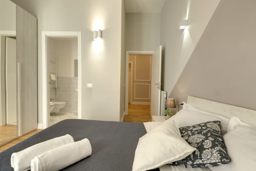 Modern bedroom at Sleep tight Florence with double bed, en-suite bathroom, and sloped ceiling in Florence