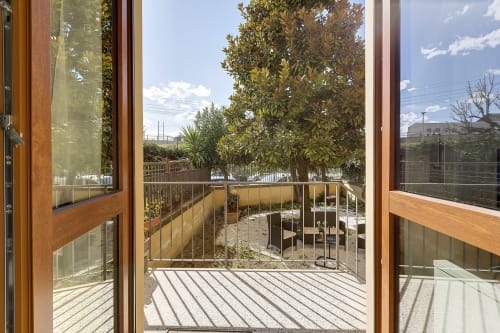 Garden view from wooden deck with trees and mountain scenery at Sleep tight Florence B&B in Firenze