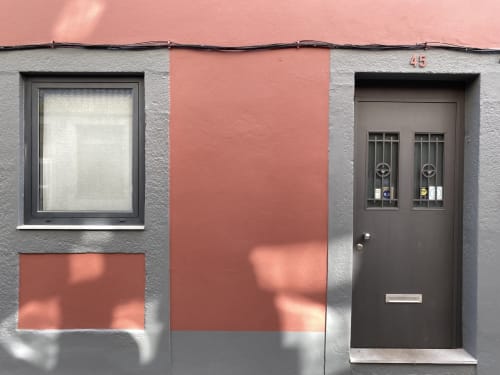 Casa45 Porto guesthouse exterior with gray and terracotta facade, window, and dark entry door number 45